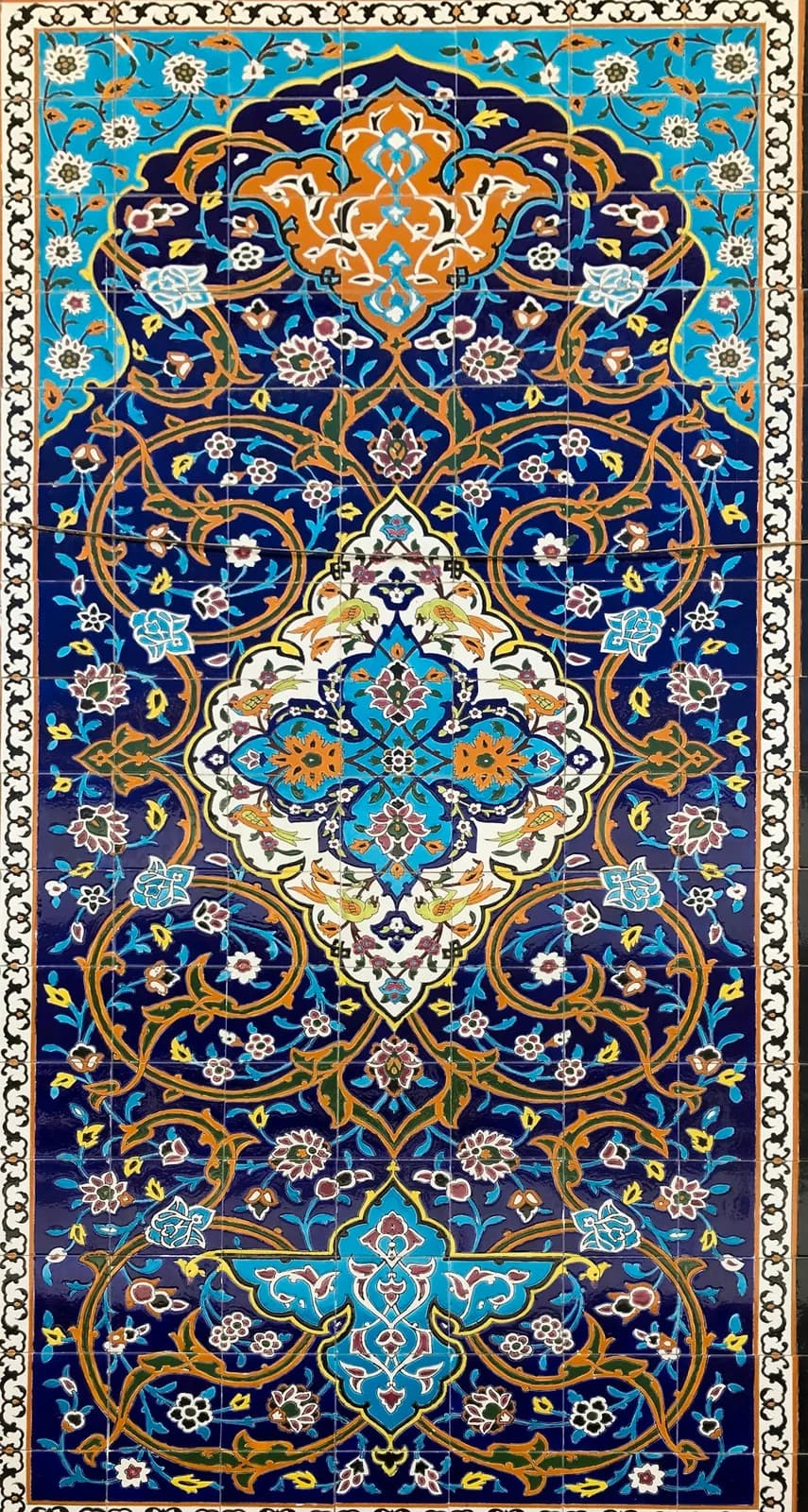 The reverse of a hand-knotted wool rug, showing the pattern repeated in individual knot nodes across the back